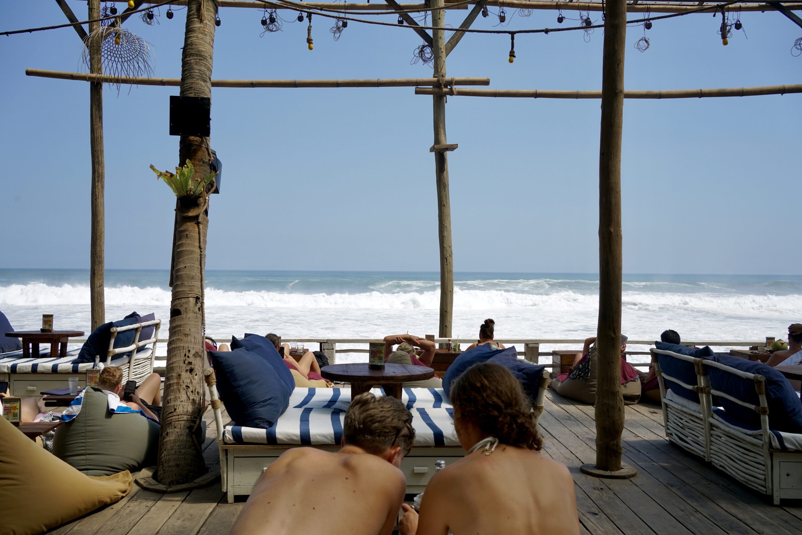 A couple at La Brisa in Canggu with the ocean in front of them