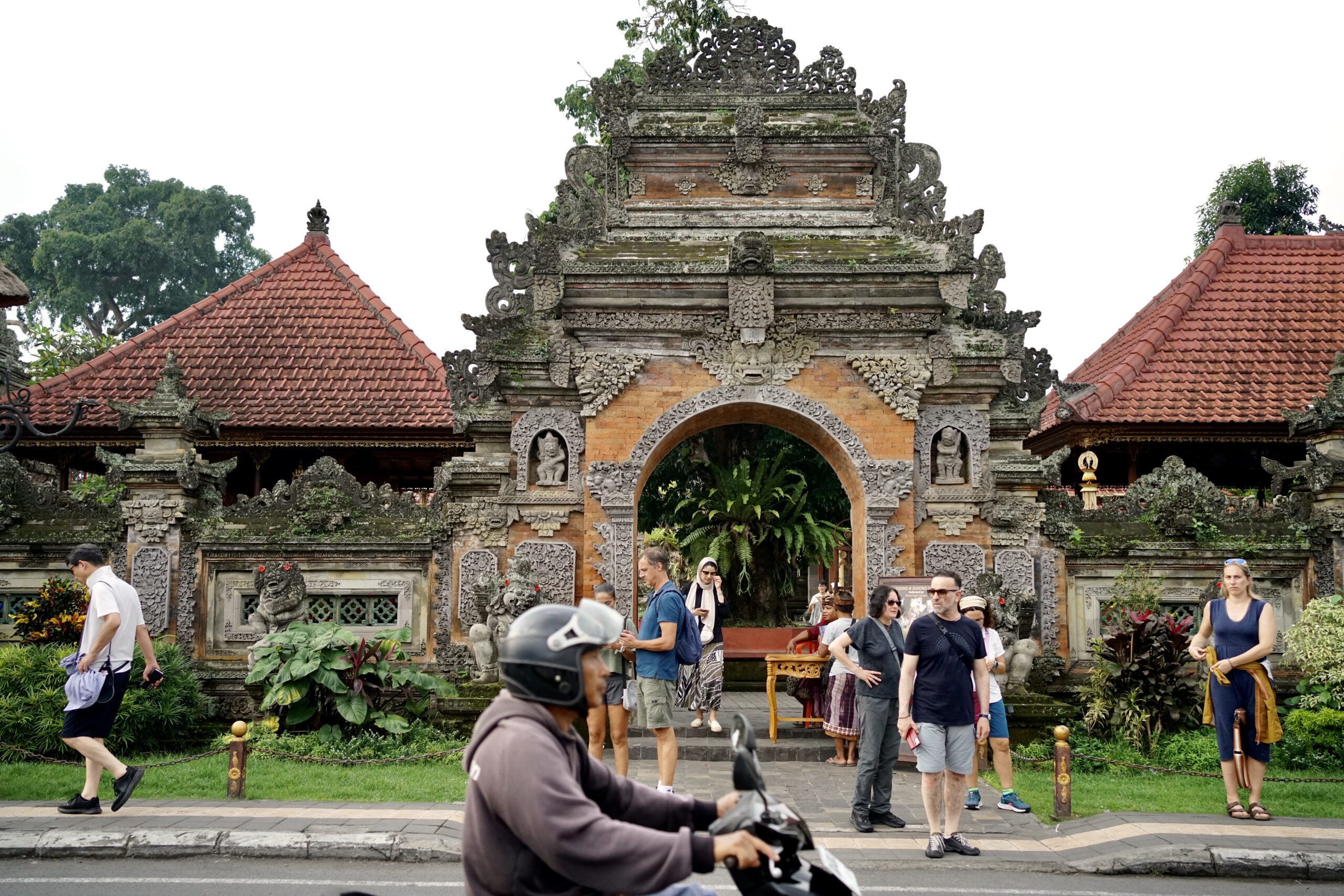 A motorbike passes by the entrance to the Ubud Palace