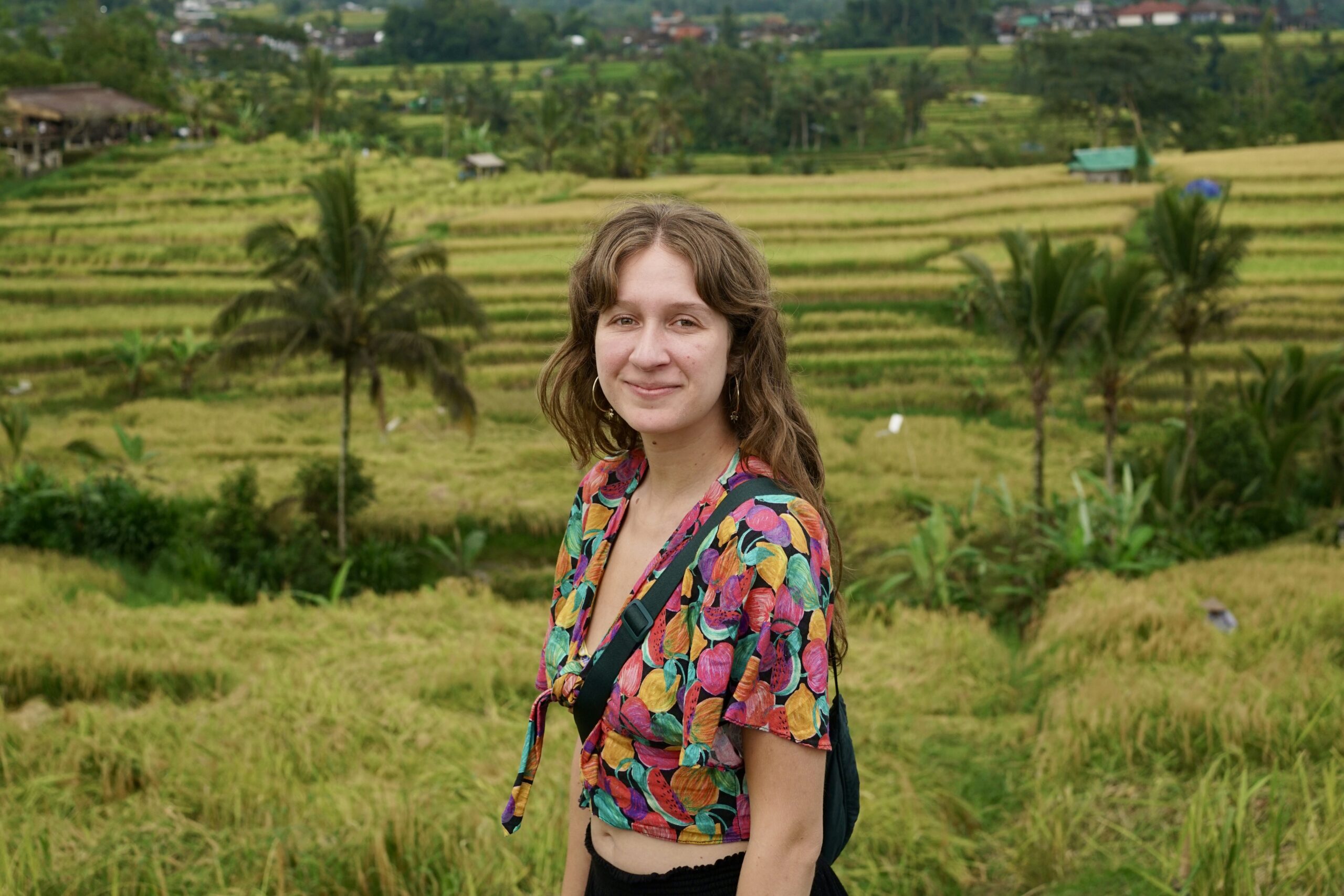 Woman stands in front of rice fields in Northern Bali