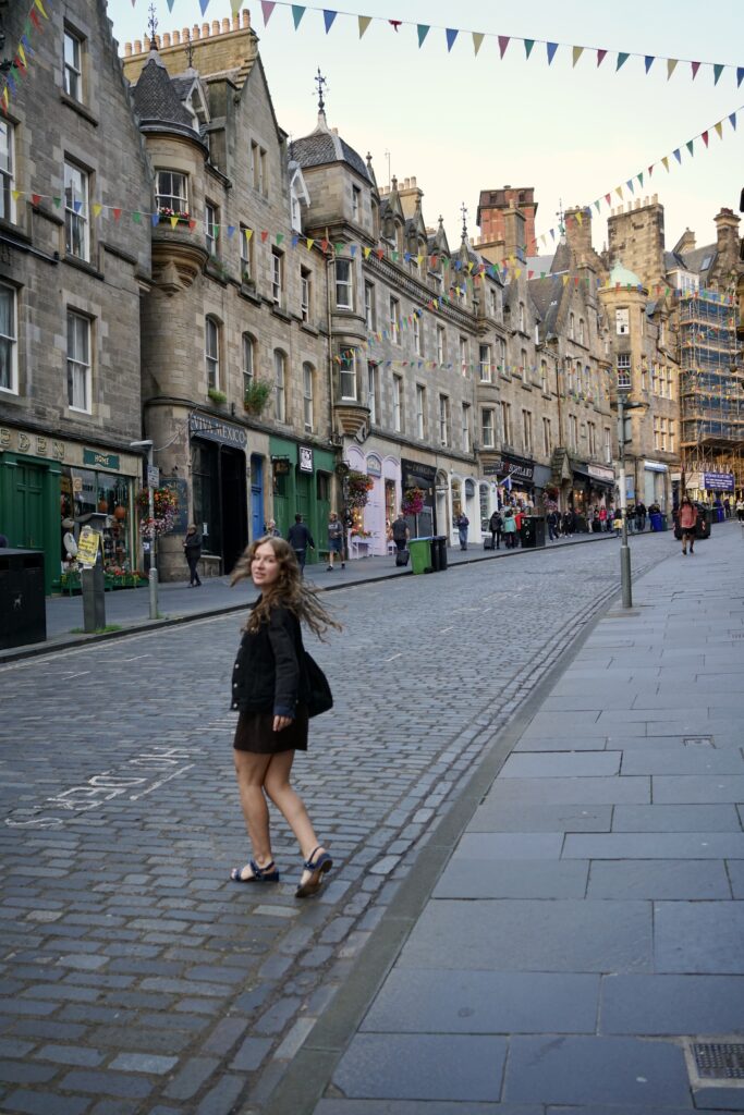 A woman walks down Cockburn Street while looking back