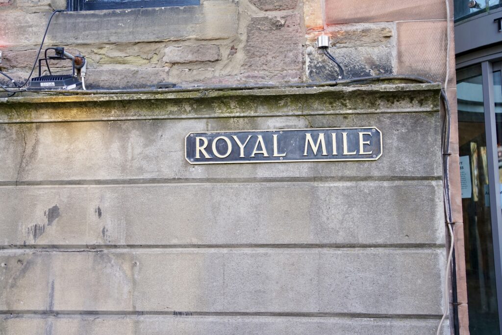A street sign on a wall for the Royal Mile