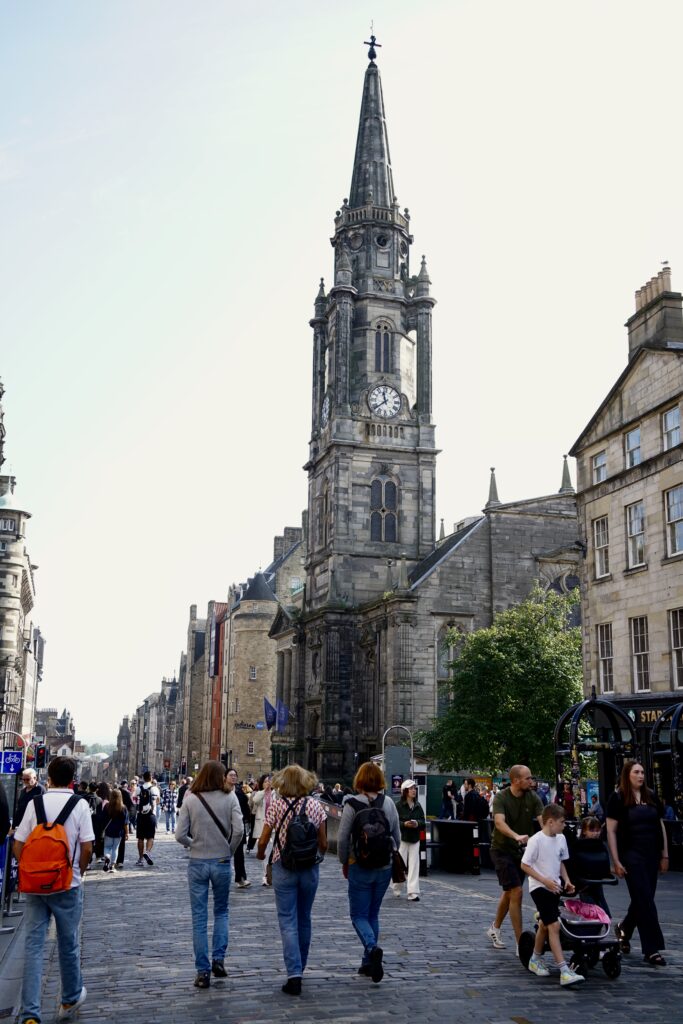 Three women walk down the Royal Mile
