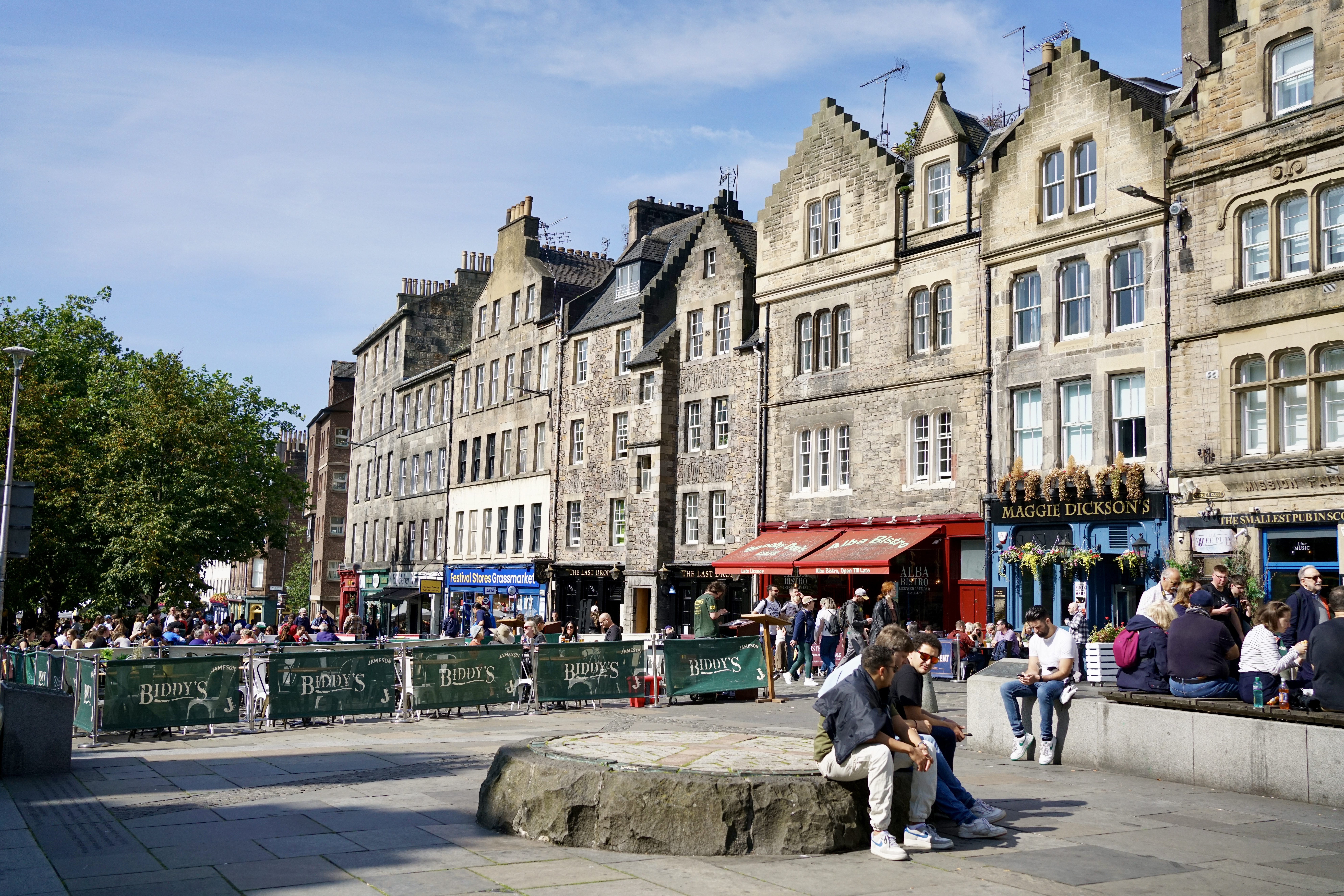 People sit in Grassmarket in Edinburgh, Scotland
