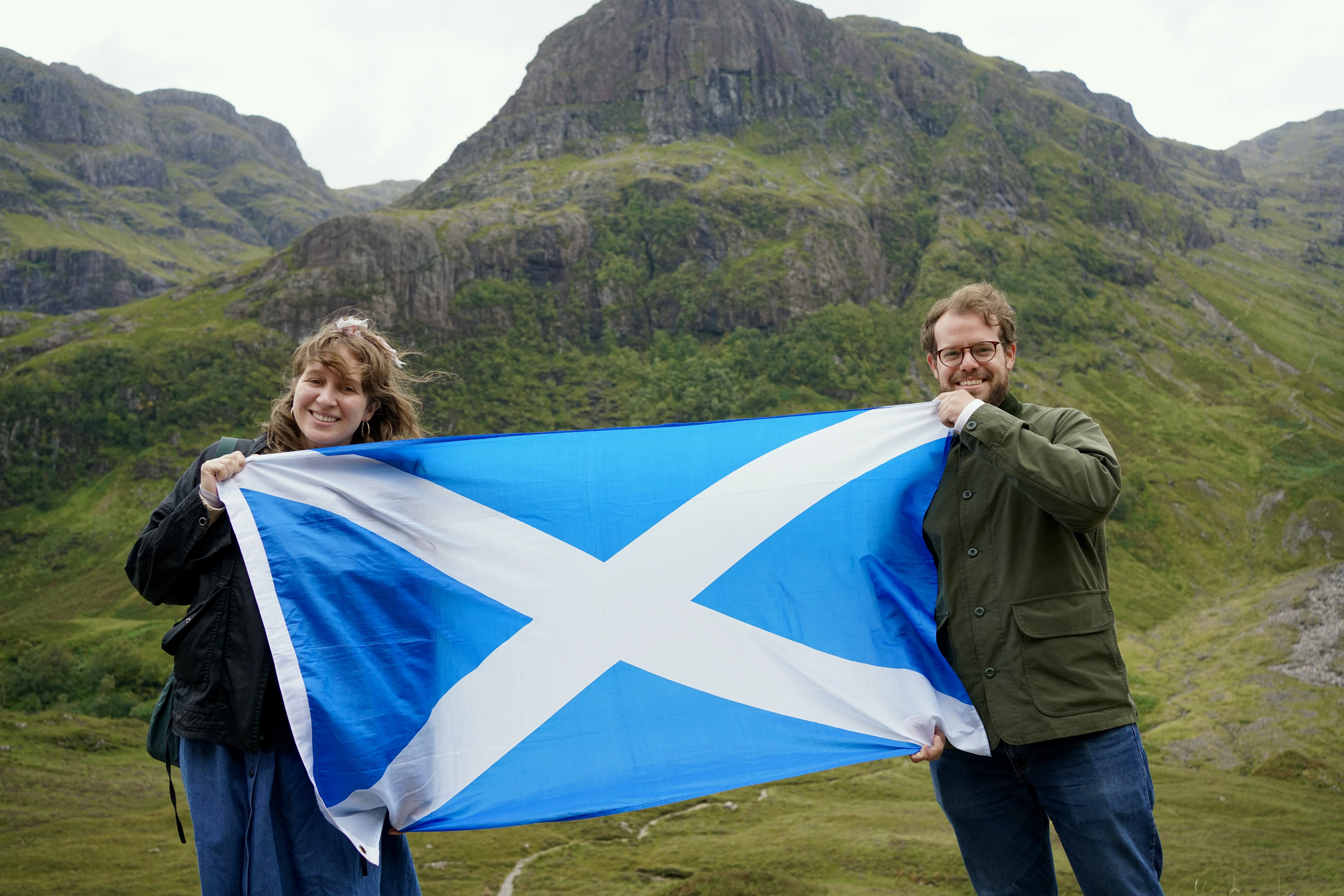 A couple holds up the Scottish flag