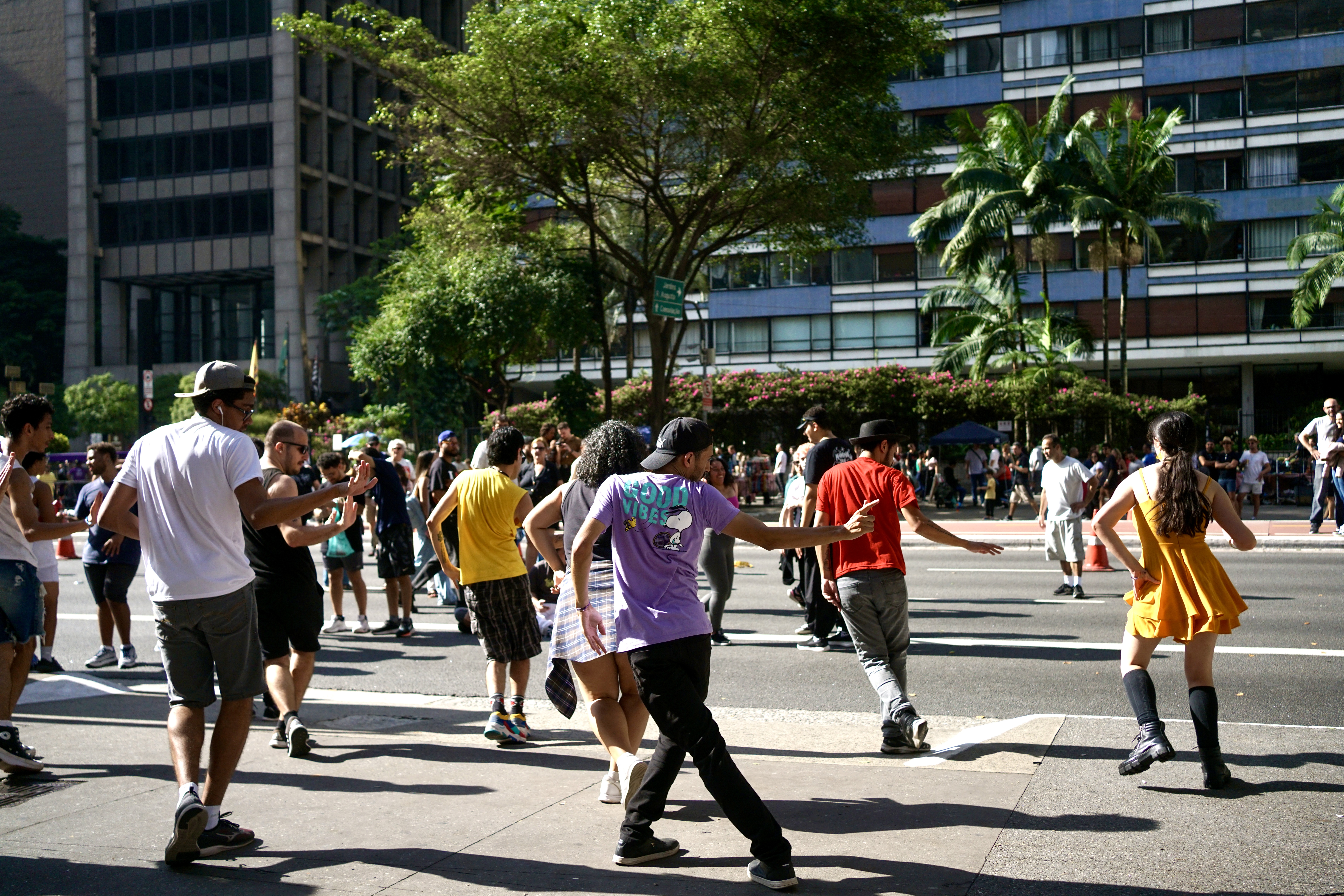 A group of people dance on the open streets of Avenida Paulista in  São Paulo