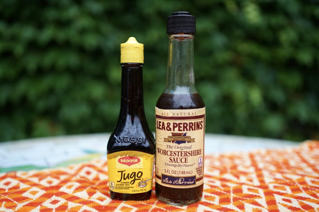 Maggi seasoning and worcestershire sauce on a table