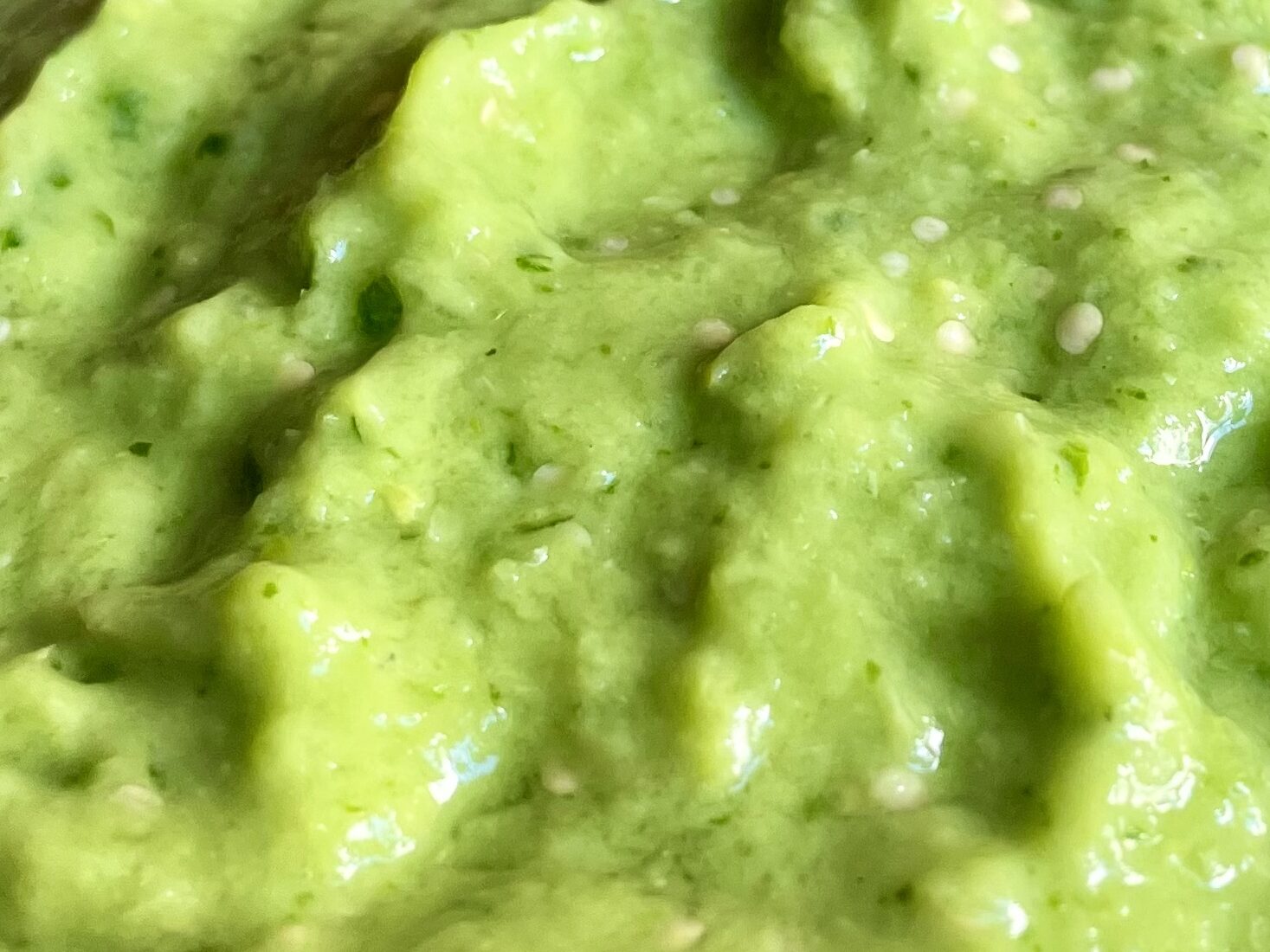 A chip in a spicy salsa verde sauce