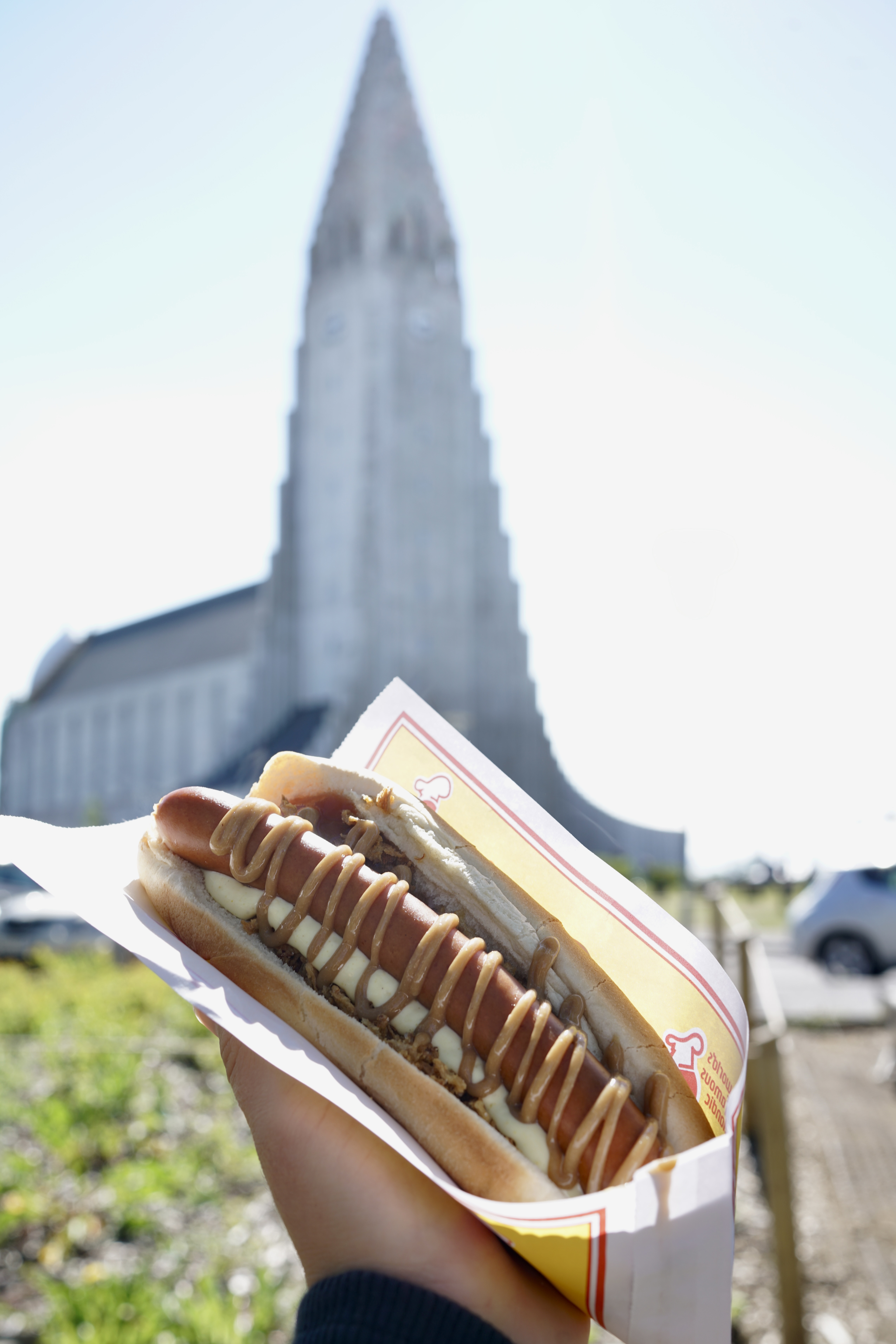 Icelandic hot dog from Víkinga in front of Hallgrimskirkja