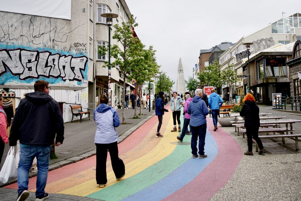 People walking on Skólavörðustígur, a rainbow painted street in Reykjavik, Iceland