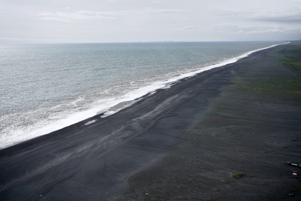 The waves crash on the shore a black beach in Iceland