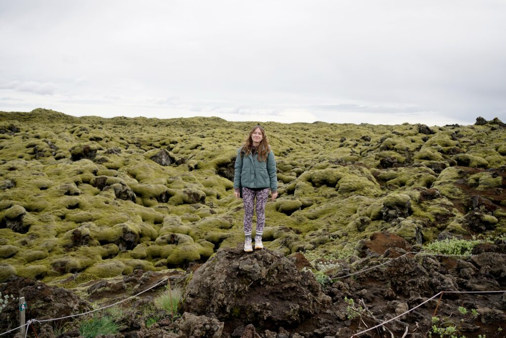 A woman stands in the Eldhraun lava field
