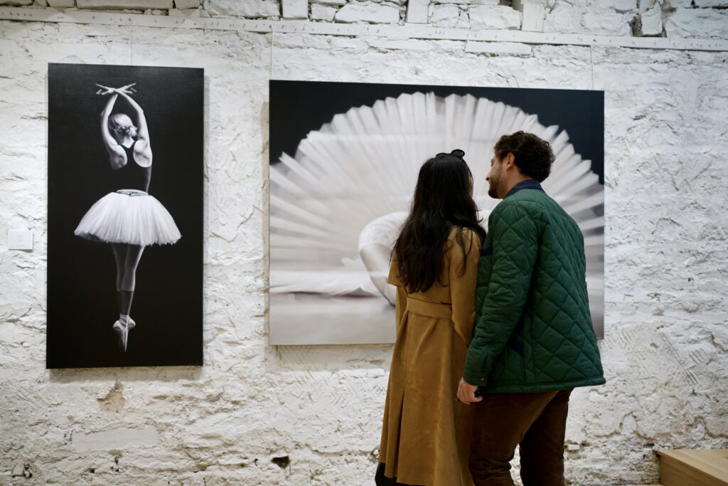 A couple looks at art in a gallery