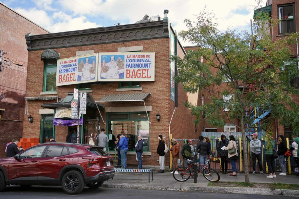 a line outside of a bagel shop