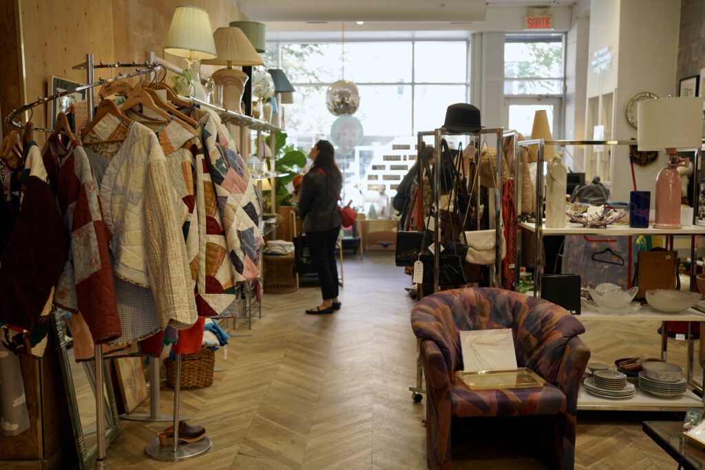 A woman looks around a secondhand vintage shop
