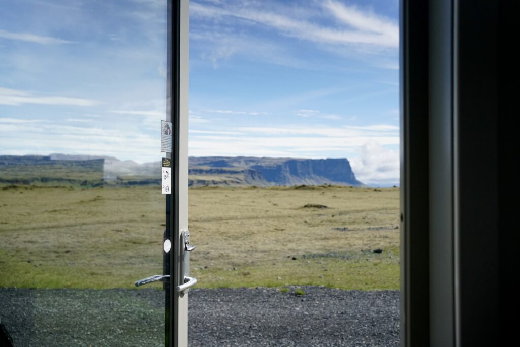 A door opens up to a view in southern Iceland