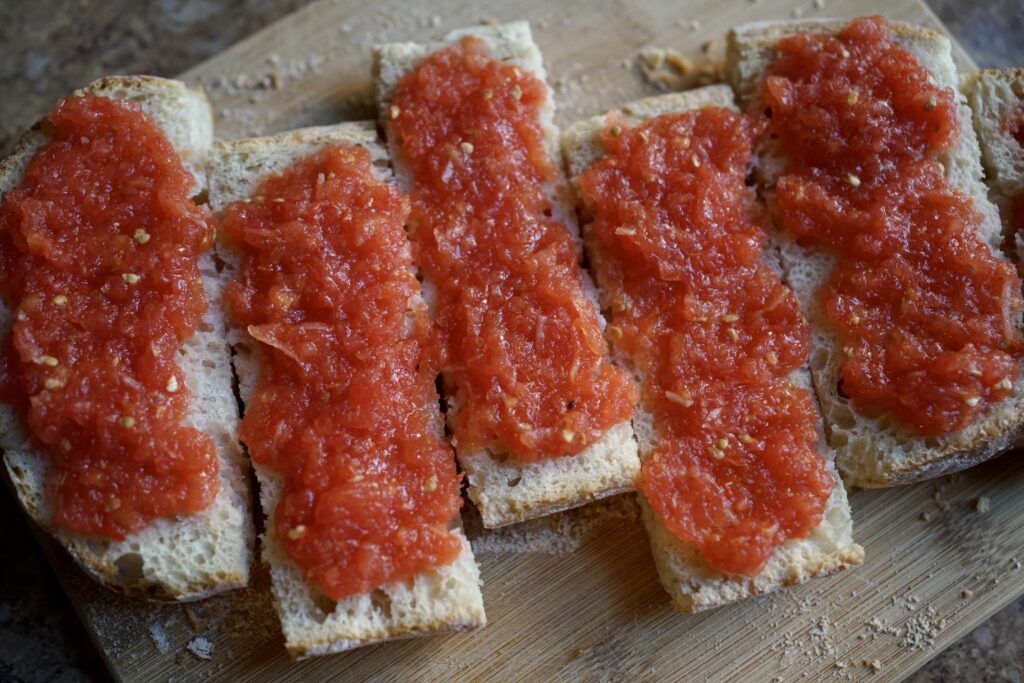 grated tomato on strips of toasted bread
