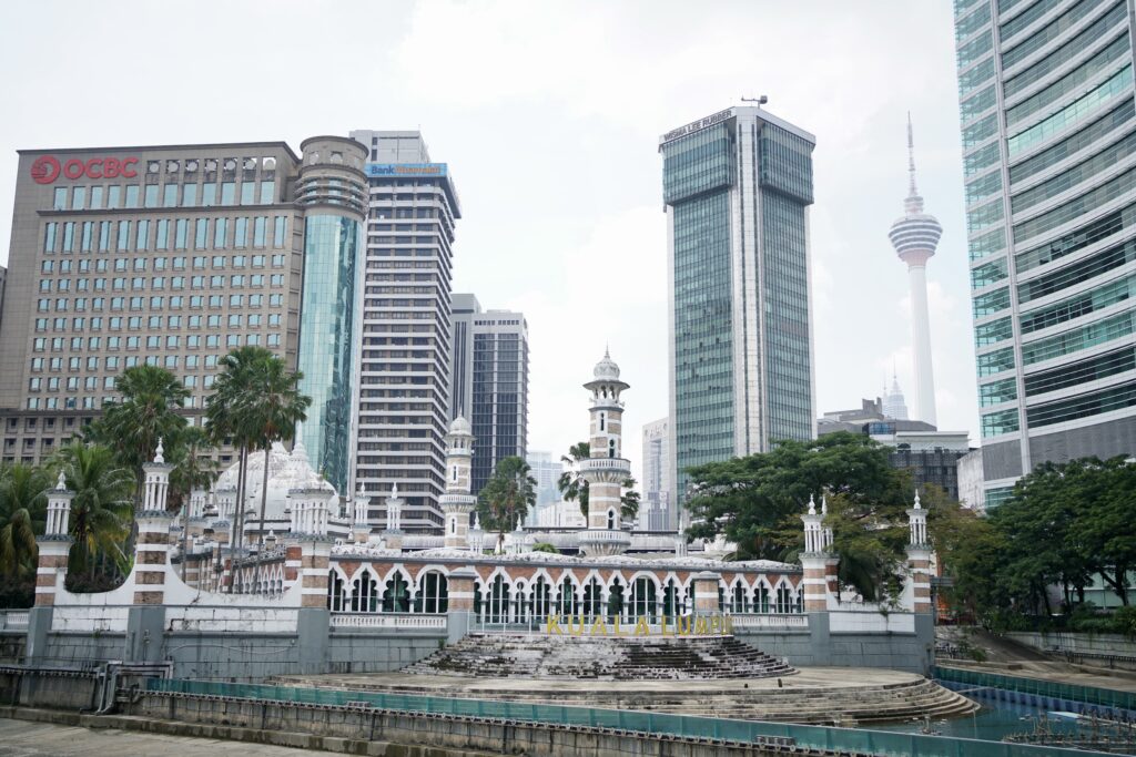 the jamek mosque in the foreground with buildings in the background