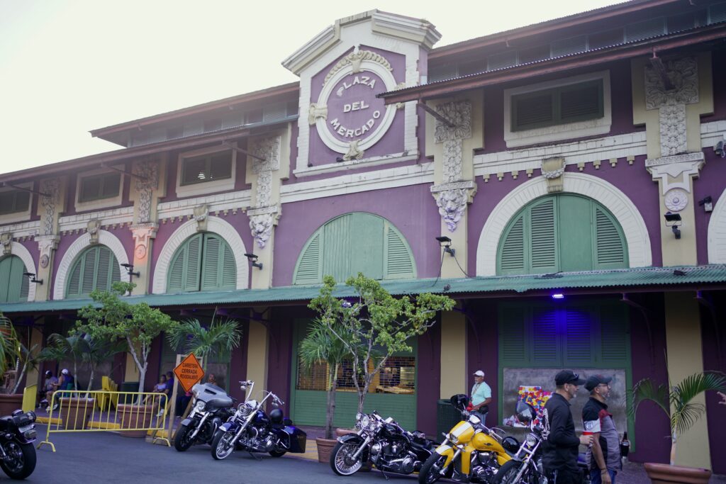 motorbikes parked in front of the main purple building of La Placita de Santurce