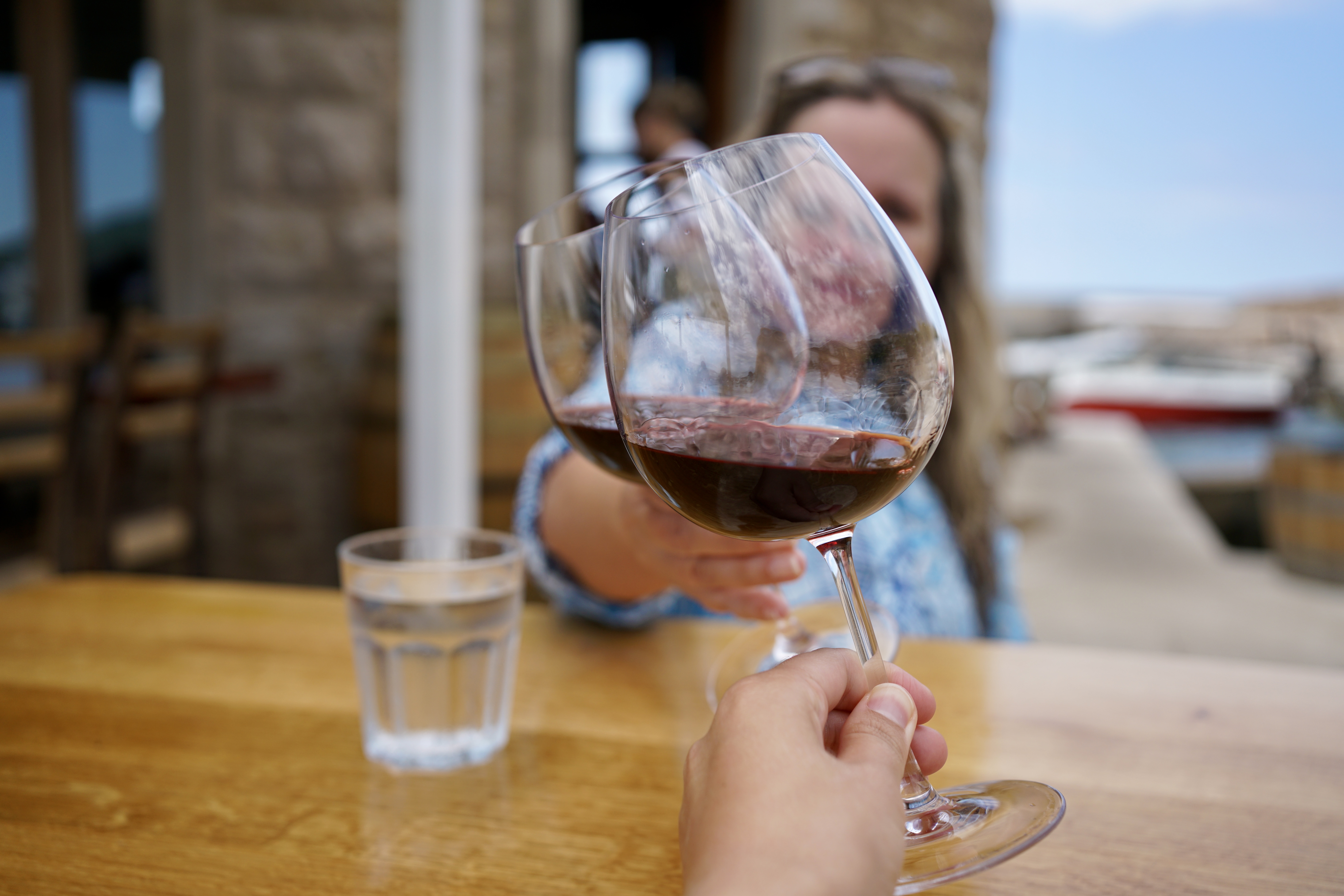 two glasses of red wine tap for a cheers